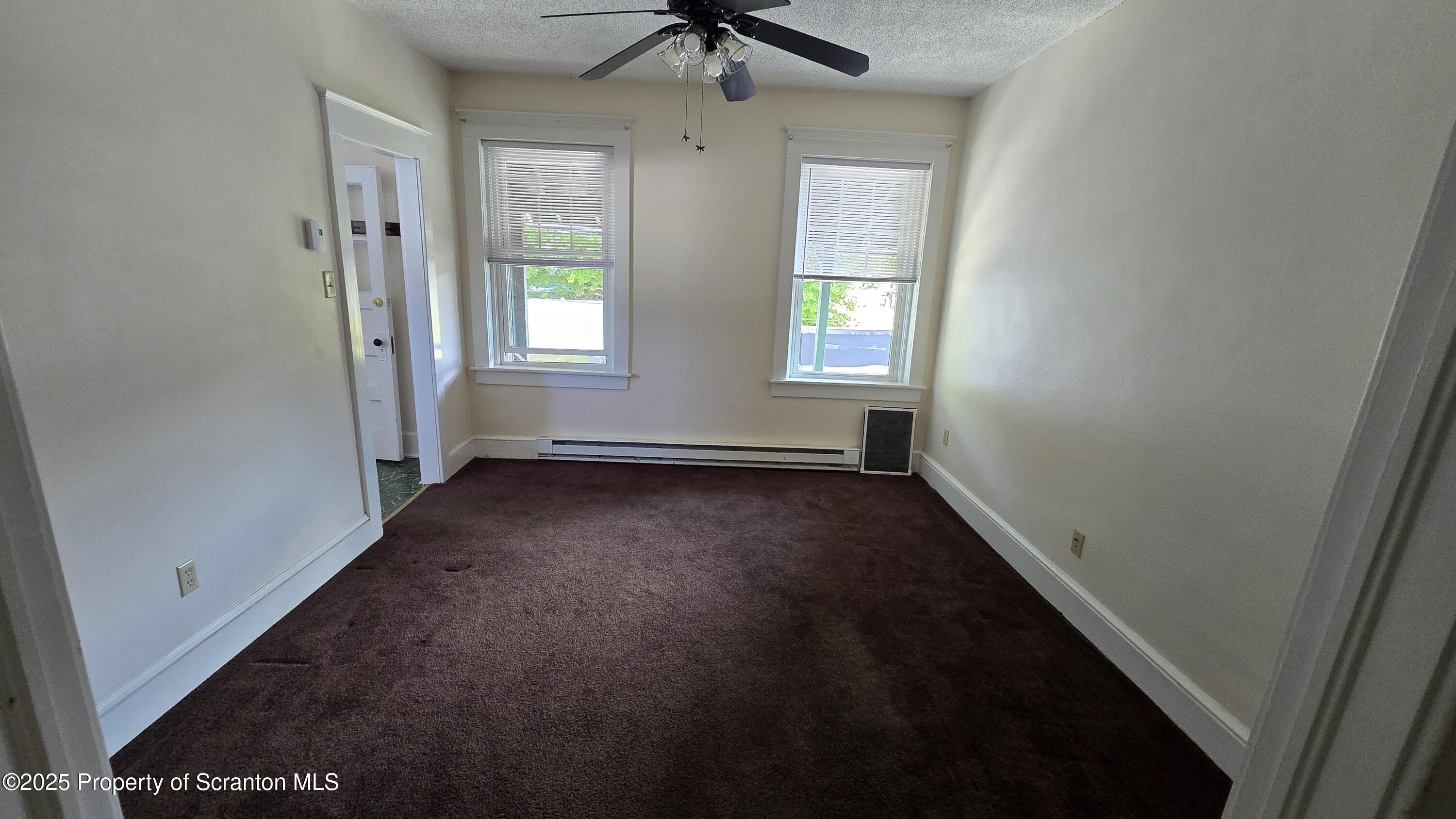 281 East Main Street, Unit 3 Plymouth, PA 18651 - Photo 4 of 9 an empty room with windows and fan