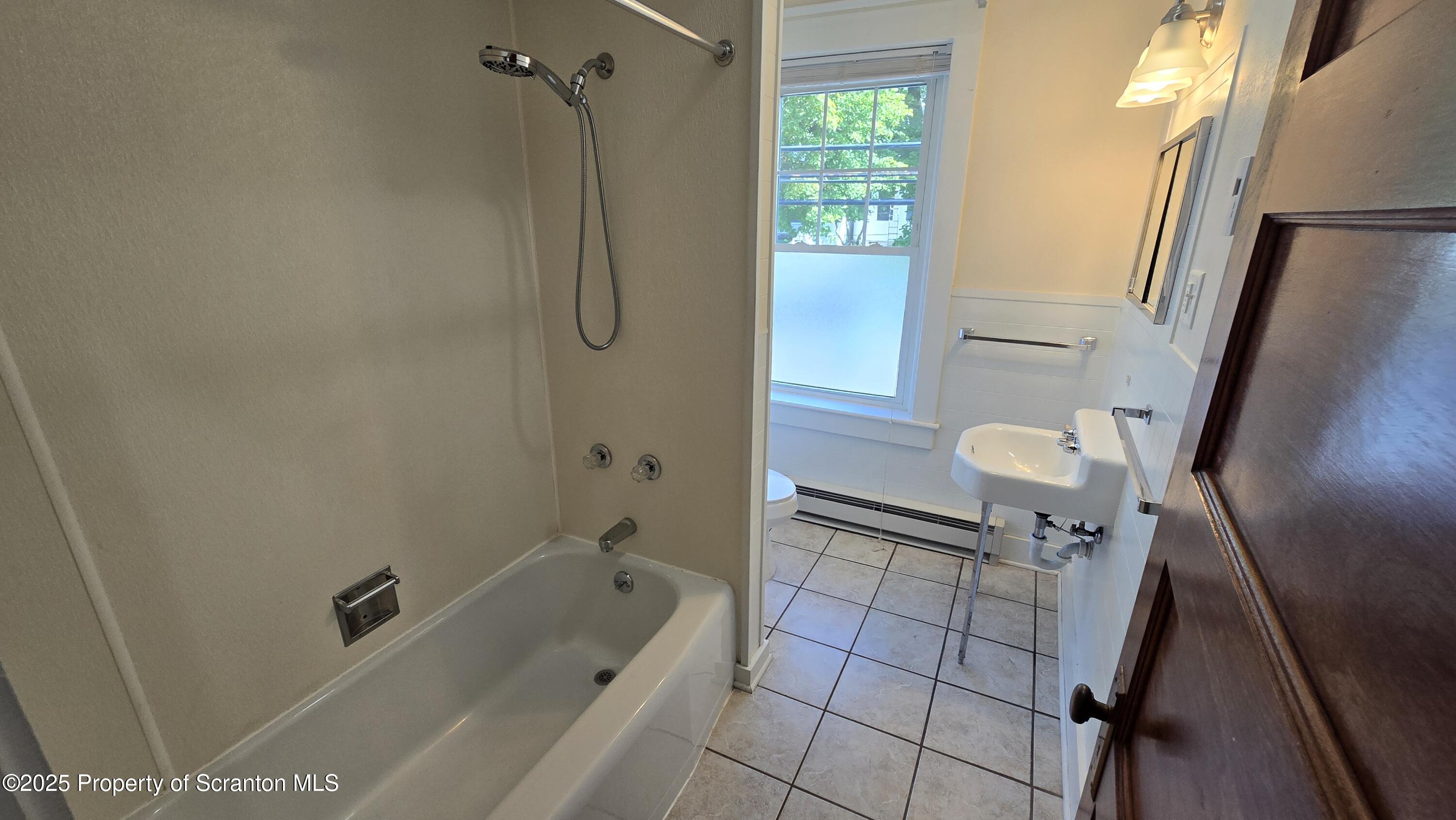 281 East Main Street, Unit 3 Plymouth, PA 18651 - Photo 7 of 9 a bathroom with a tub a sink and a shower