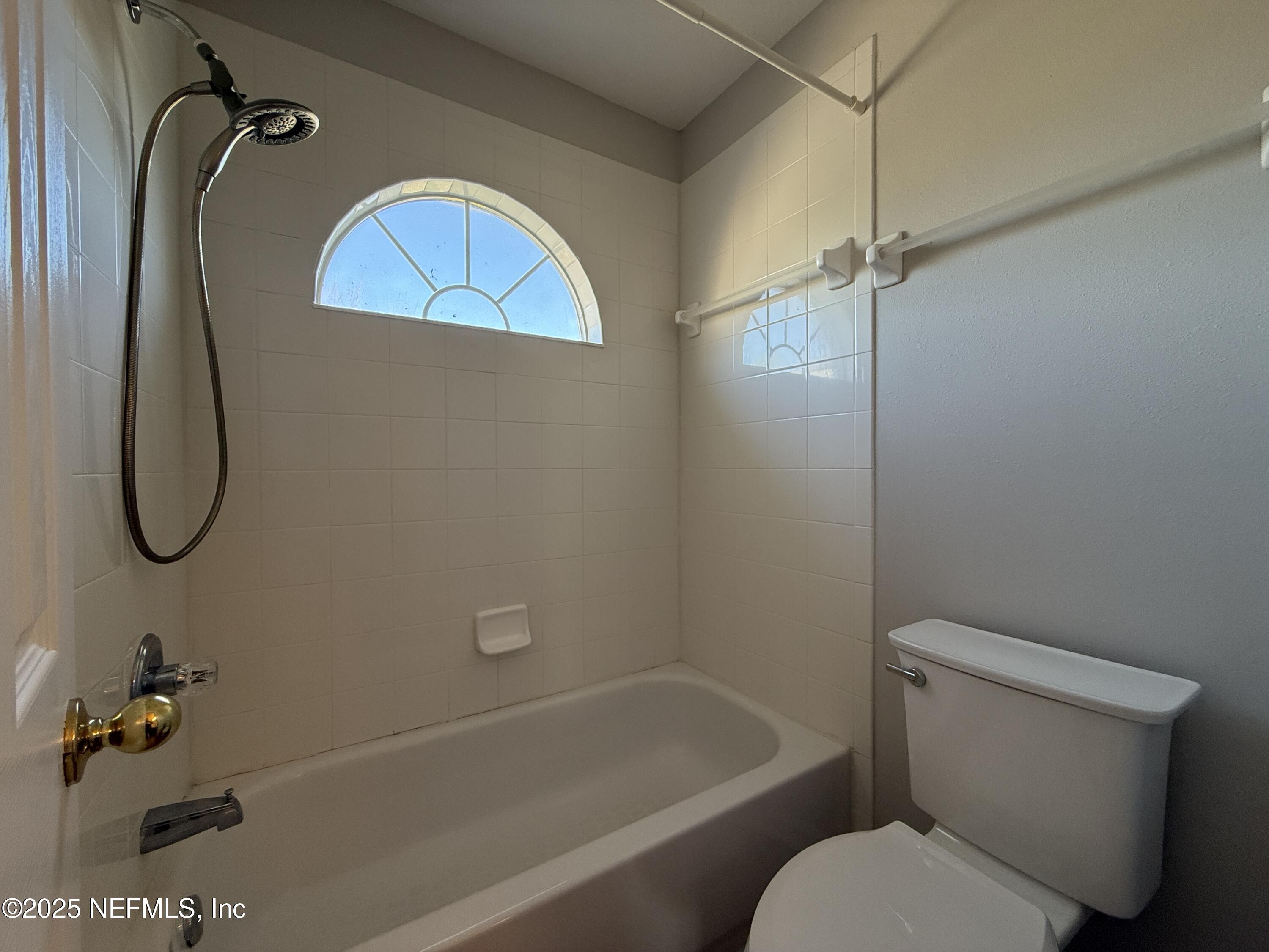 1865 Green Springs Circle, Unit C Fleming Island, FL 32003 - Photo 14 of 29 a bathroom with a toilet and a shower