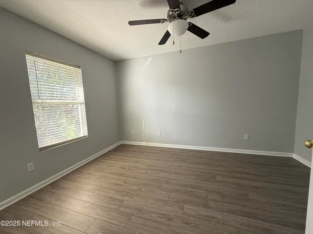 an aerial view of a house with a garden and trees