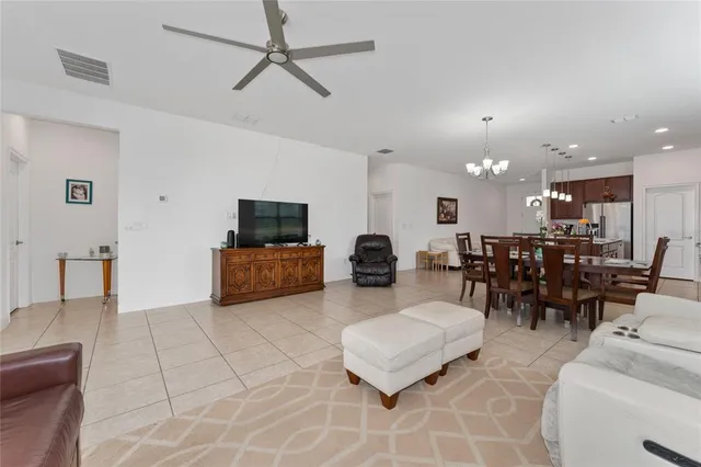 a living room with furniture and kitchen view