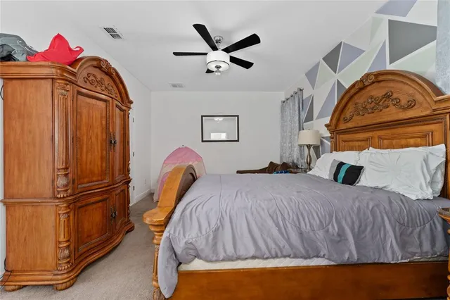 a bedroom with a bed and a painting on the wall