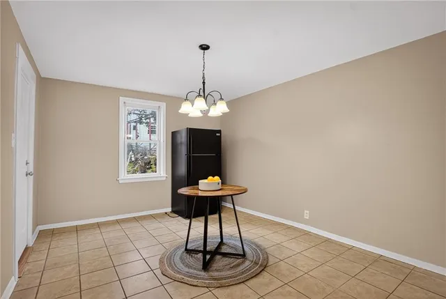 a room with a table and a chandelier