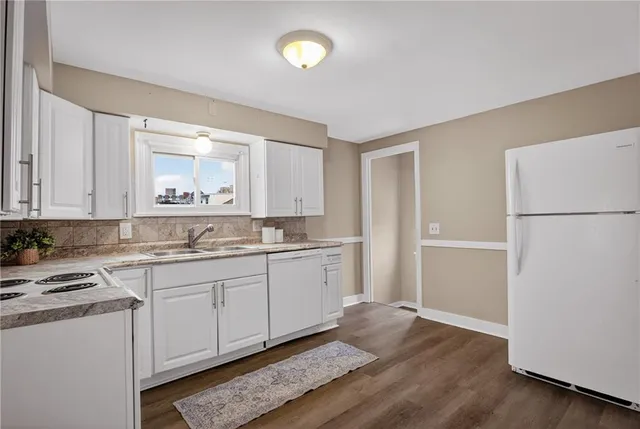 a view of a room with wooden floor