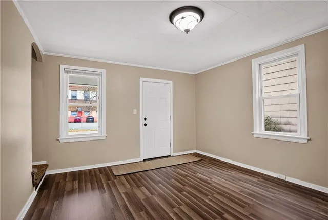 a view of room with window and wooden floor