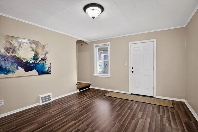 a view of a room with wooden floor and window