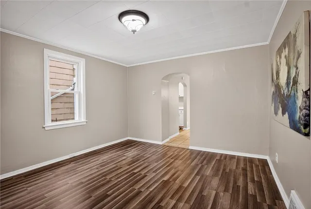 a view of a livingroom with wooden floor and window