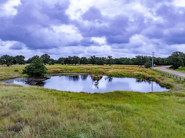 a view of a lake with houses in the back