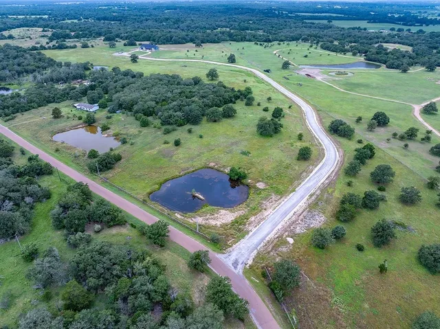 an aerial view of a golf course with outdoor space