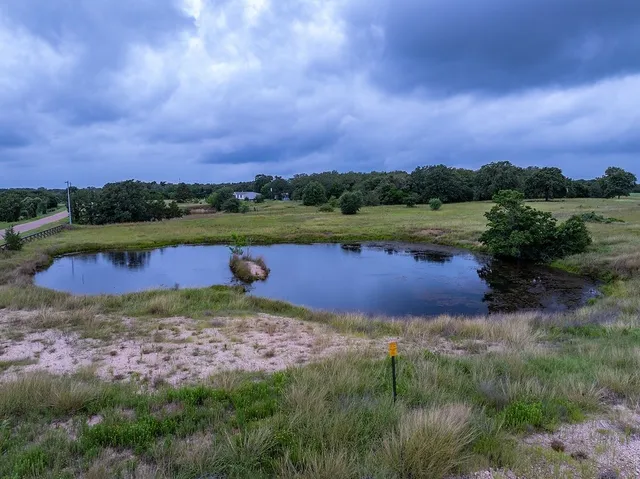 a view of a lake with houses in the back