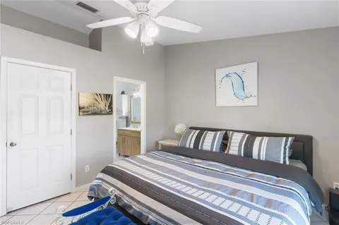 a bedroom with a large bed and a chandelier