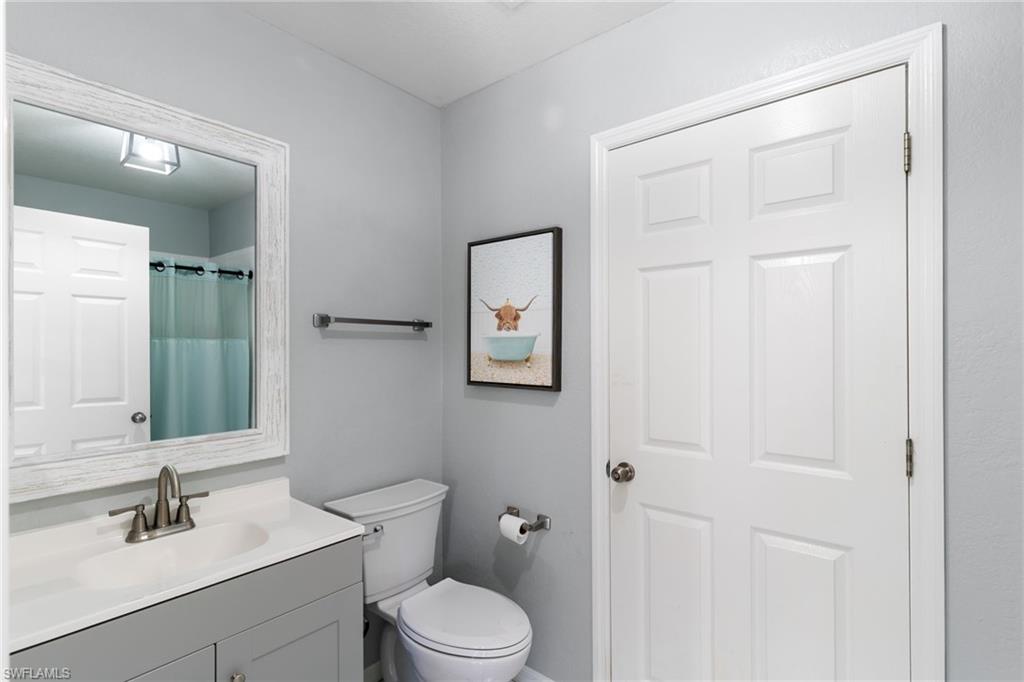 1061 15th Street Southwest Naples, FL 34117 - Photo 20 of 47 a bathroom with a toilet a sink and mirror