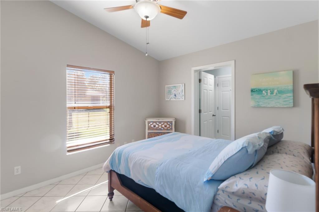 1061 15th Street Southwest Naples, FL 34117 - Photo 21 of 47 a bedroom with a bed and a chandelier