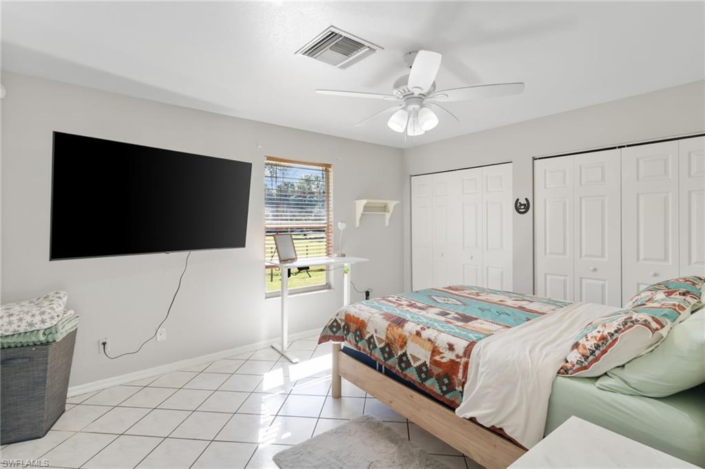 1061 15th Street Southwest Naples, FL 34117 - Photo 22 of 47 a bedroom with a bed and a flat screen tv