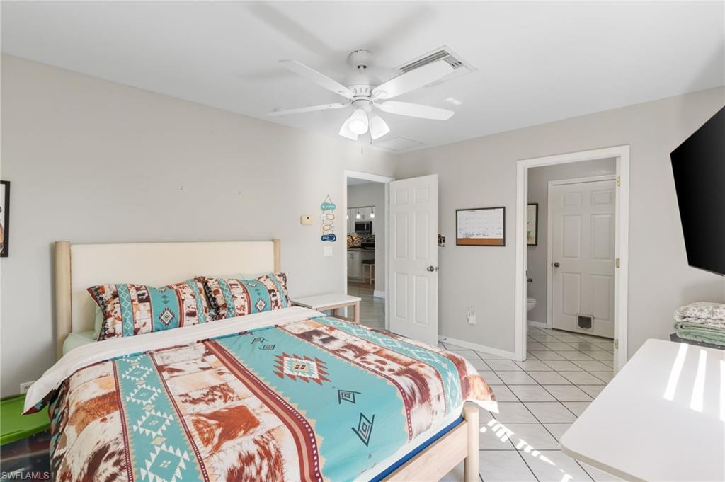 1061 15th Street Southwest Naples, FL 34117 - Photo 23 of 47 a bedroom with a bed and a tv