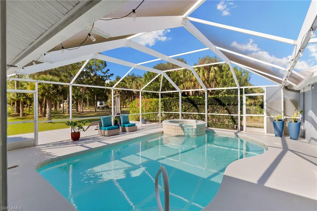 1061 15th Street Southwest Naples, FL 34117 - Photo 27 of 47 a view of a swimming pool with a patio
