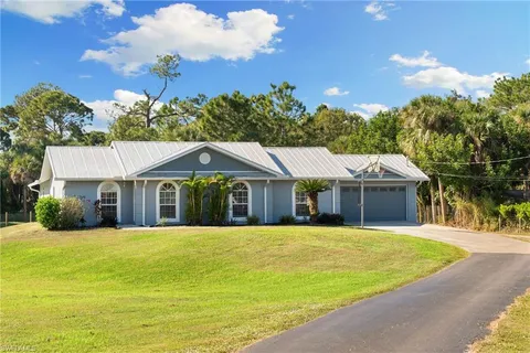 a view of a house with swimming pool and a yard