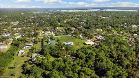 a view of a city with lush green forest