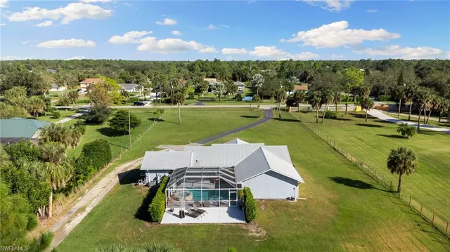 an aerial view of a house with a big yard