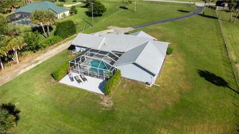 an aerial view of a house with a garden and swimming pool