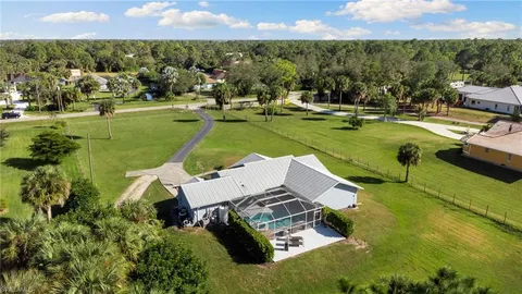 an aerial view of a house with a garden and lake view