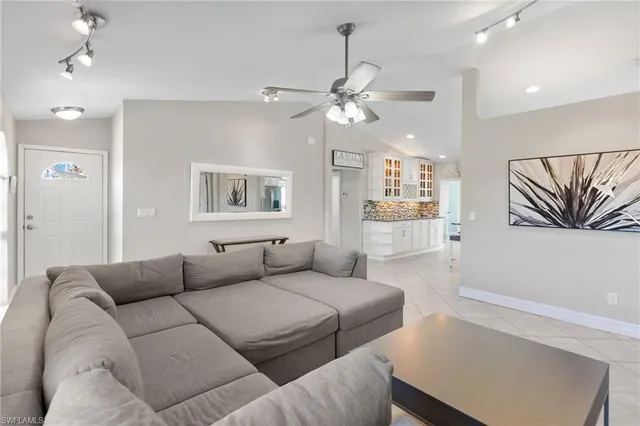 a living room with furniture and a ceiling fan