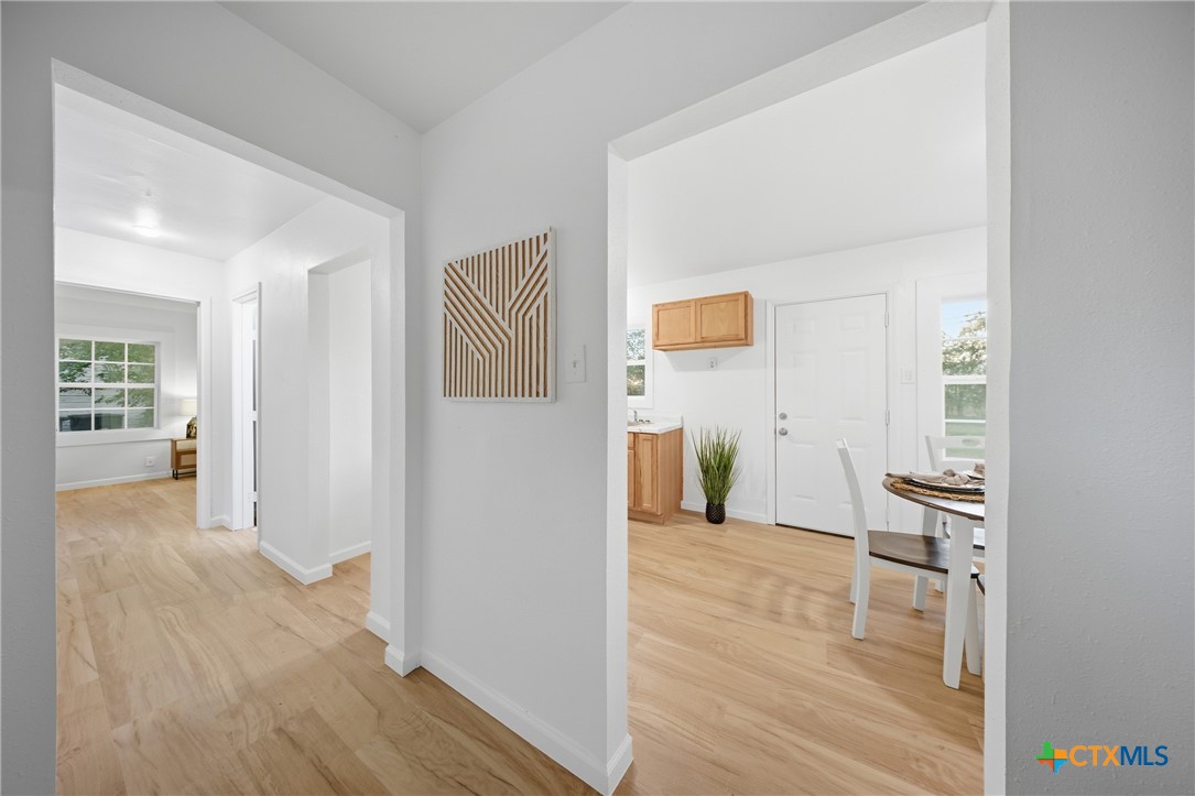 918 Fannin Loop Temple, TX 76501 - Photo 11 of 31 a view of a hallway with wooden floor and a living room