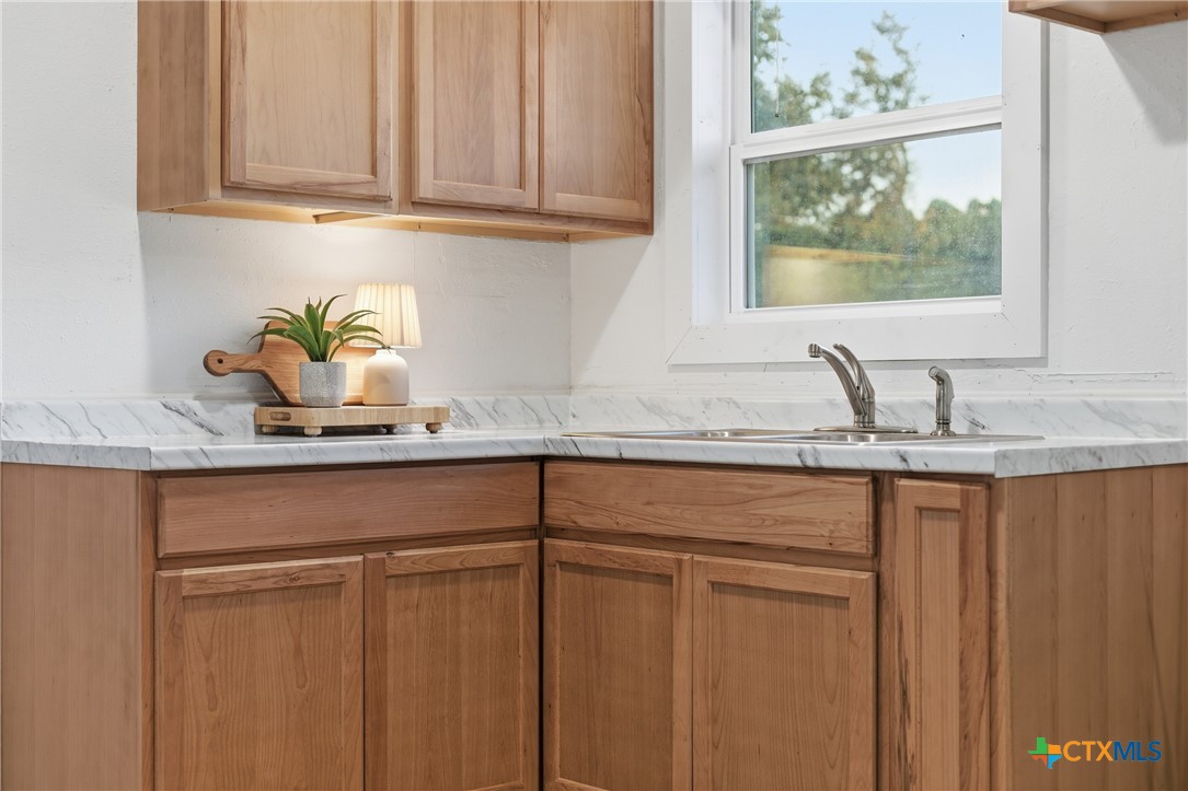 918 Fannin Loop Temple, TX 76501 - Photo 13 of 31 a kitchen with stainless steel appliances granite countertop white cabinets a sink and dishwasher