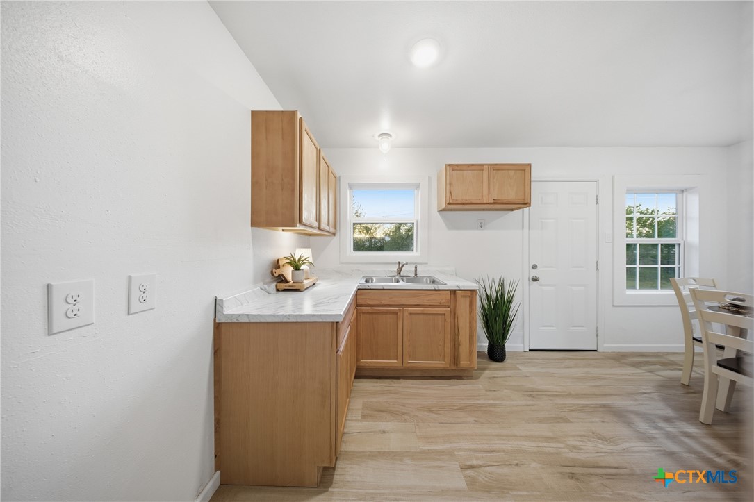 918 Fannin Loop Temple, TX 76501 - Photo 14 of 31 a kitchen with stainless steel appliances granite countertop a stove a sink and a refrigerator