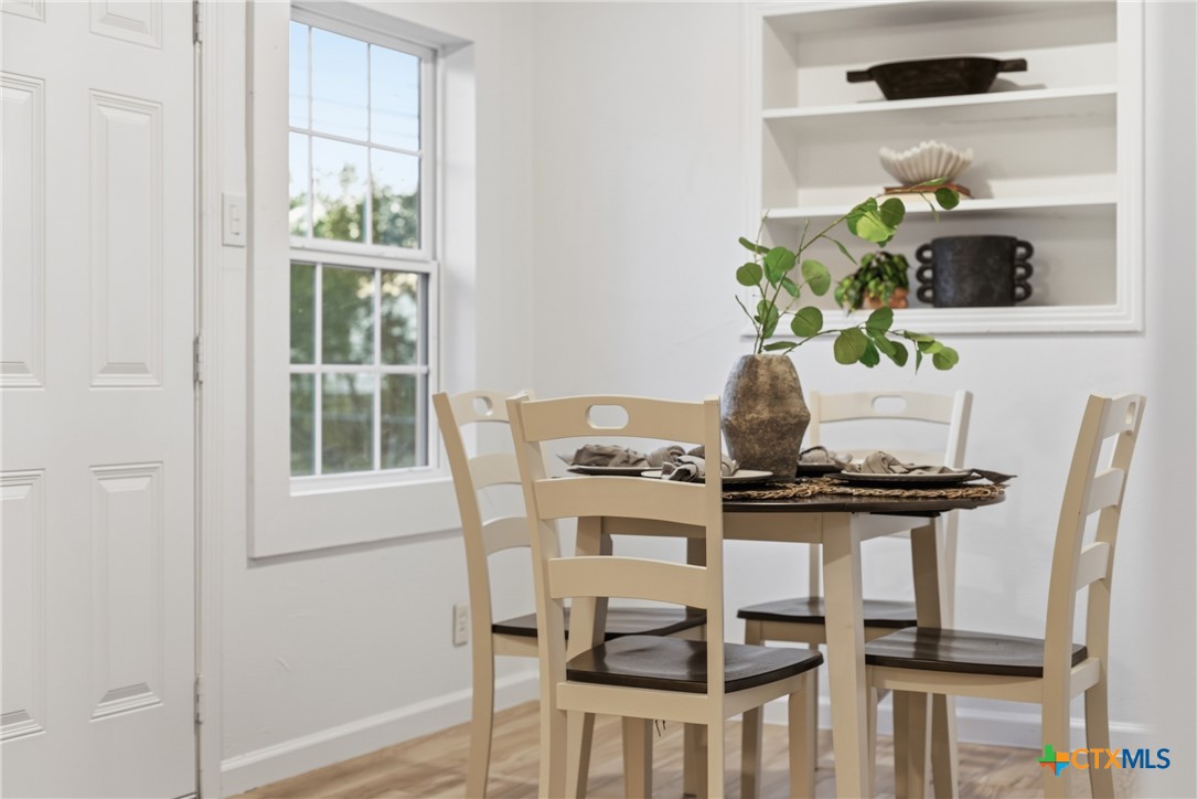 918 Fannin Loop Temple, TX 76501 - Photo 16 of 31 a view of a dining room with furniture a potted plant and wooden floor