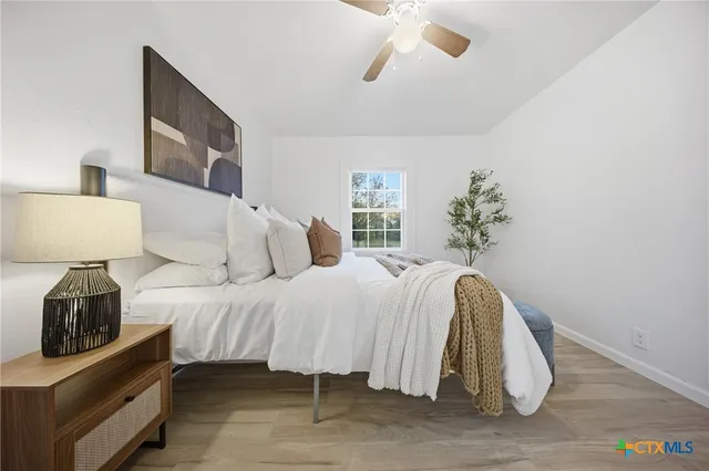 a bedroom with a bed and a lamp