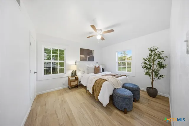 a bed room with bed and windows