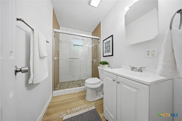 a bathroom with a sink toilet and shower