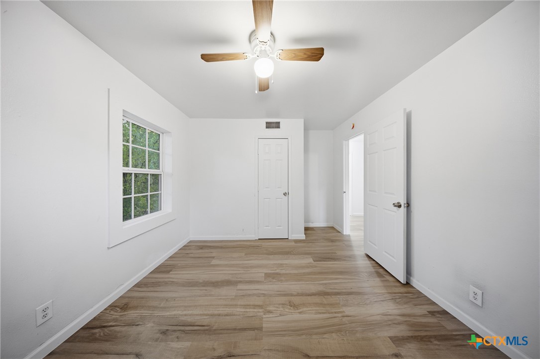918 Fannin Loop Temple, TX 76501 - Photo 23 of 31 a view of an empty room with wooden floor and a window