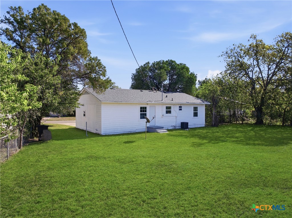 918 Fannin Loop Temple, TX 76501 - Photo 28 of 31 a backyard of a house with table and chairs plants and large tree