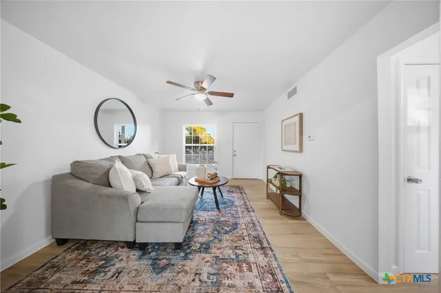 a living room with furniture and a rug