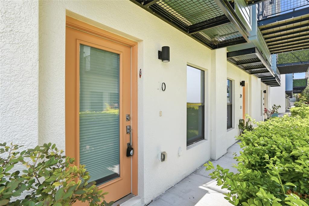 4810 West McElroy Avenue, Unit 30 Tampa, FL 33611 - Photo 6 of 43 a front view of a house with a yard