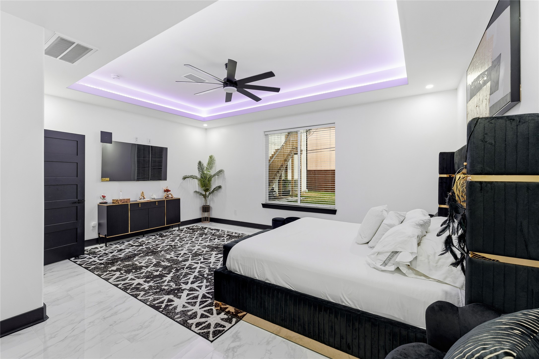 7737 Edna Street Houston, TX 77087 - Photo 11 of 43 a bedroom with a bed window and a flat screen tv