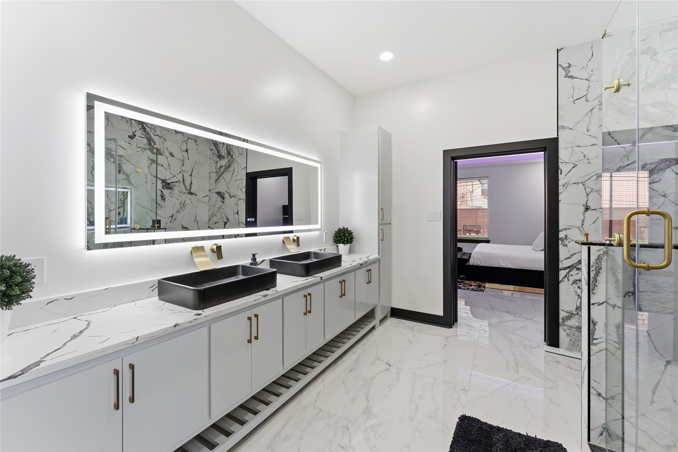 7737 Edna Street Houston, TX 77087 - Photo 14 of 43 a spacious bathroom with a double vanity sink and a mirror