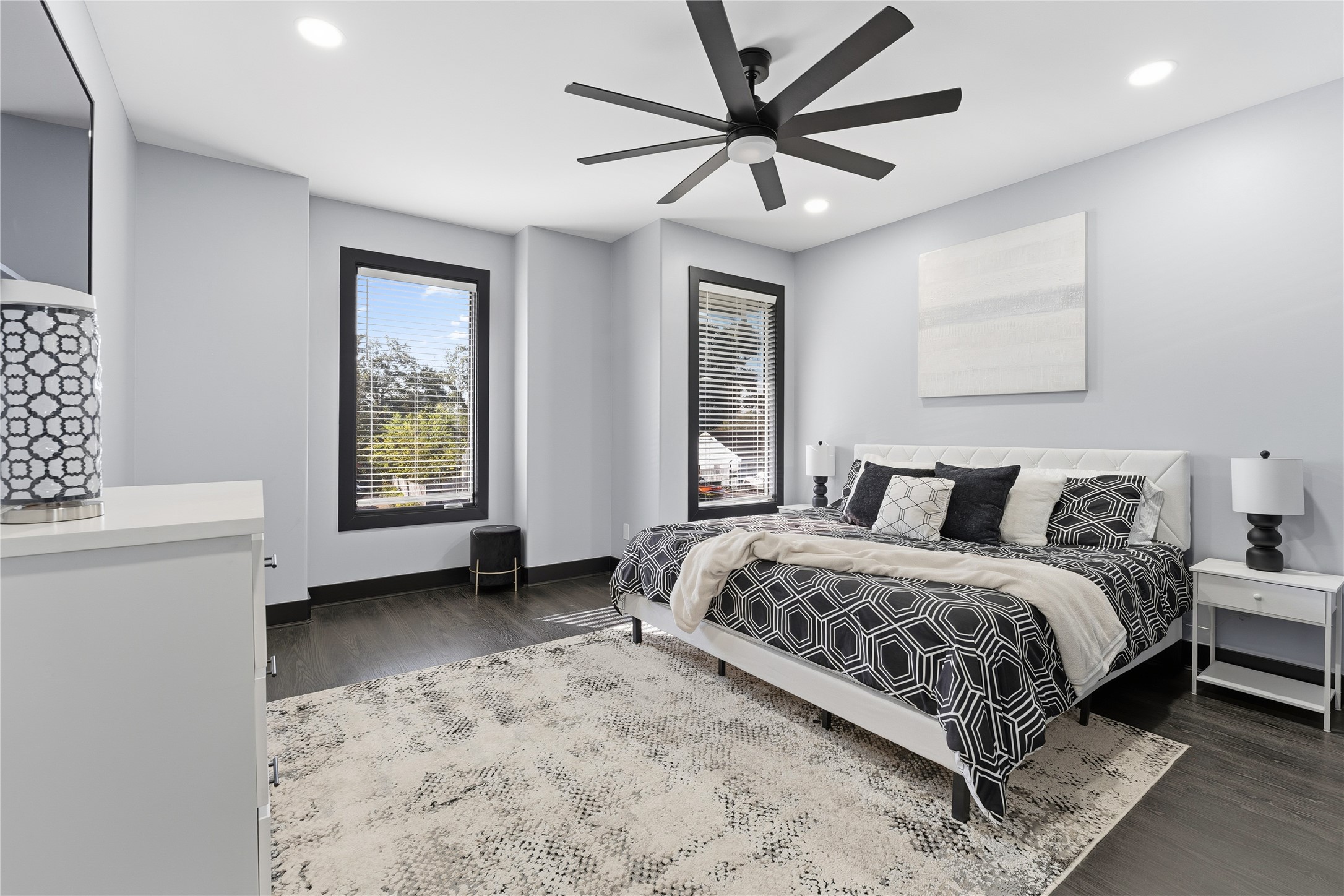 7737 Edna Street Houston, TX 77087 - Photo 19 of 43 a spacious bedroom with a bed a window and a chandelier