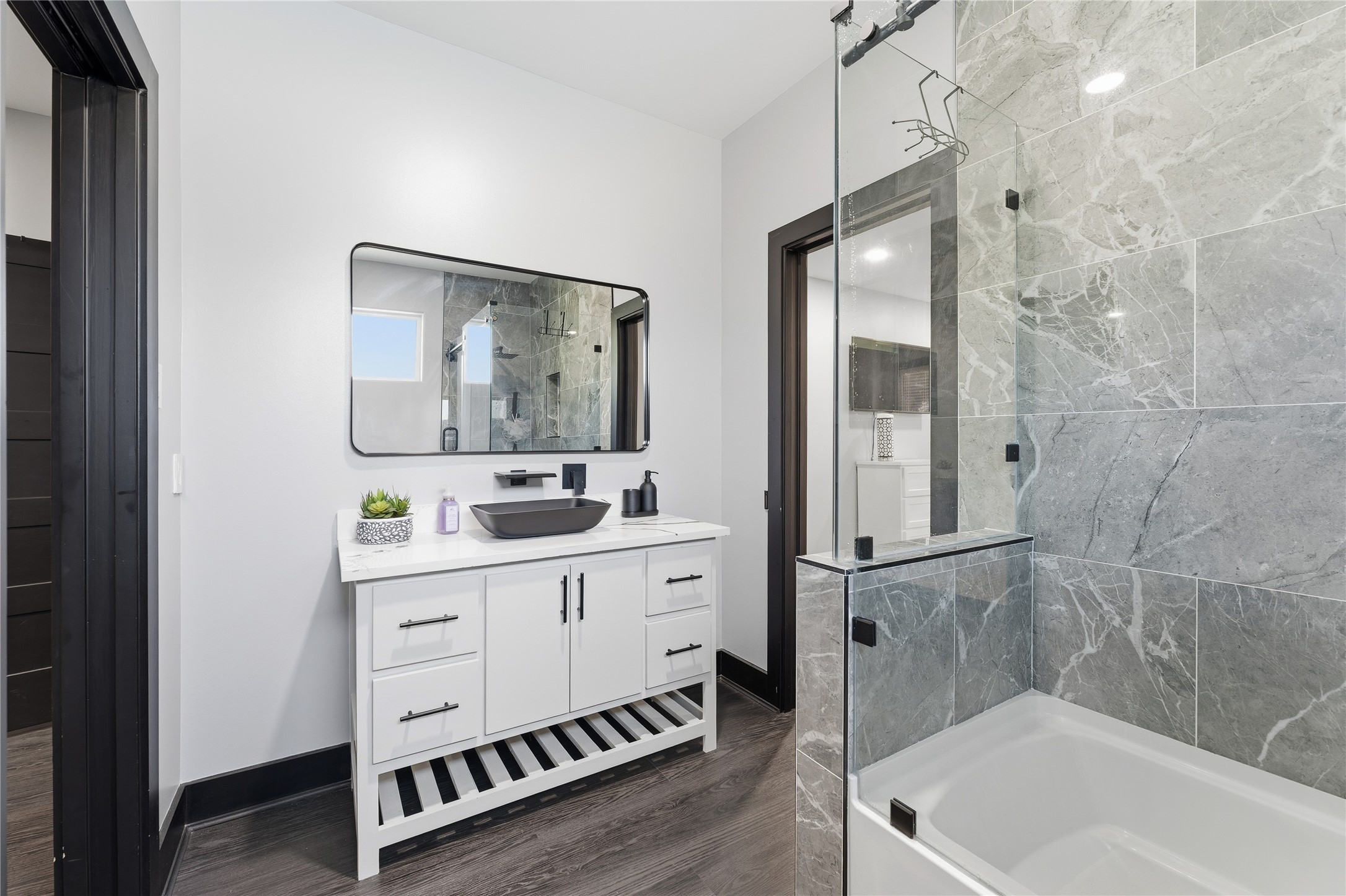 7737 Edna Street Houston, TX 77087 - Photo 21 of 43 a bathroom with a tub sink shower and mirror