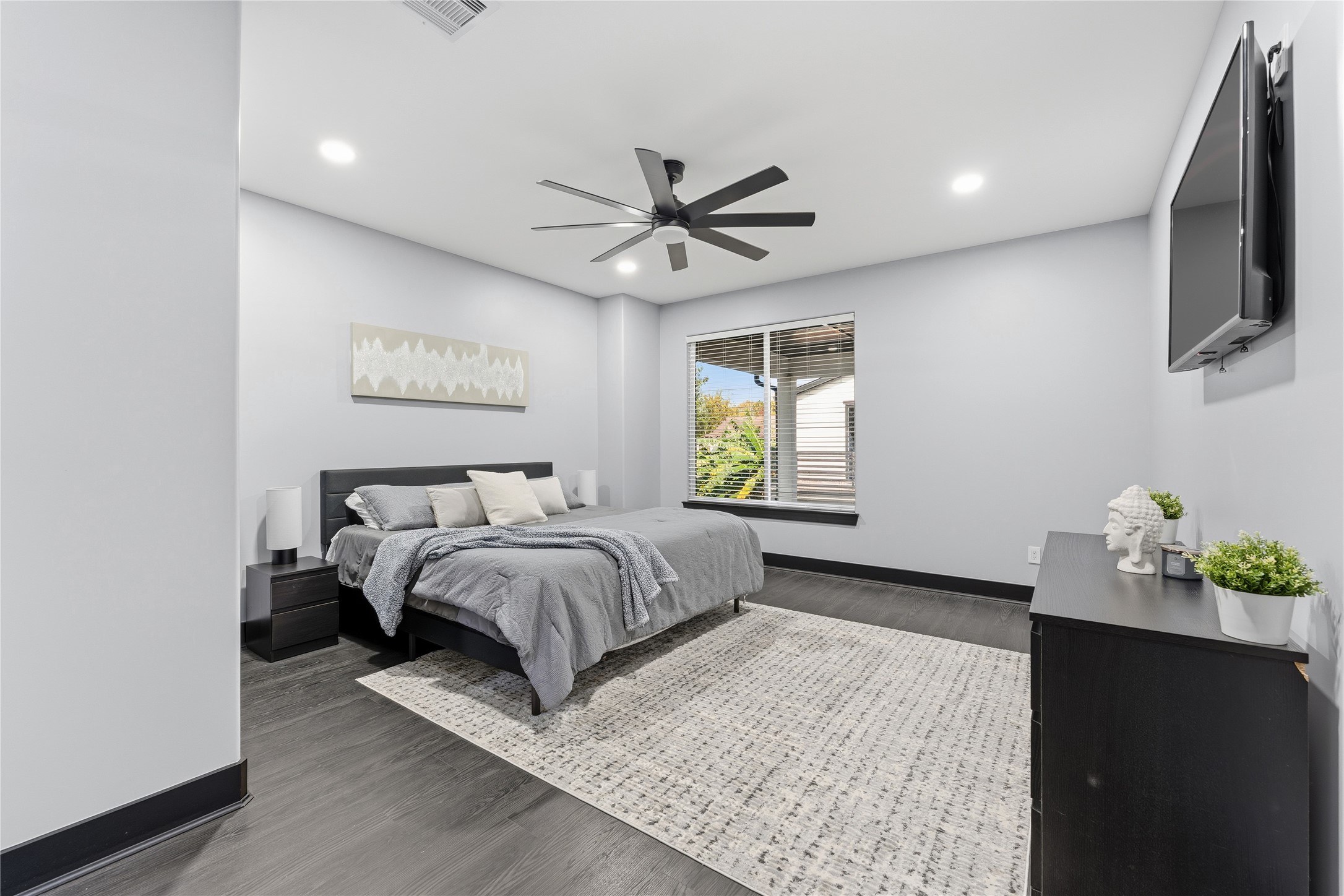 7737 Edna Street Houston, TX 77087 - Photo 22 of 43 a bed sitting in a spacious bedroom next to a window