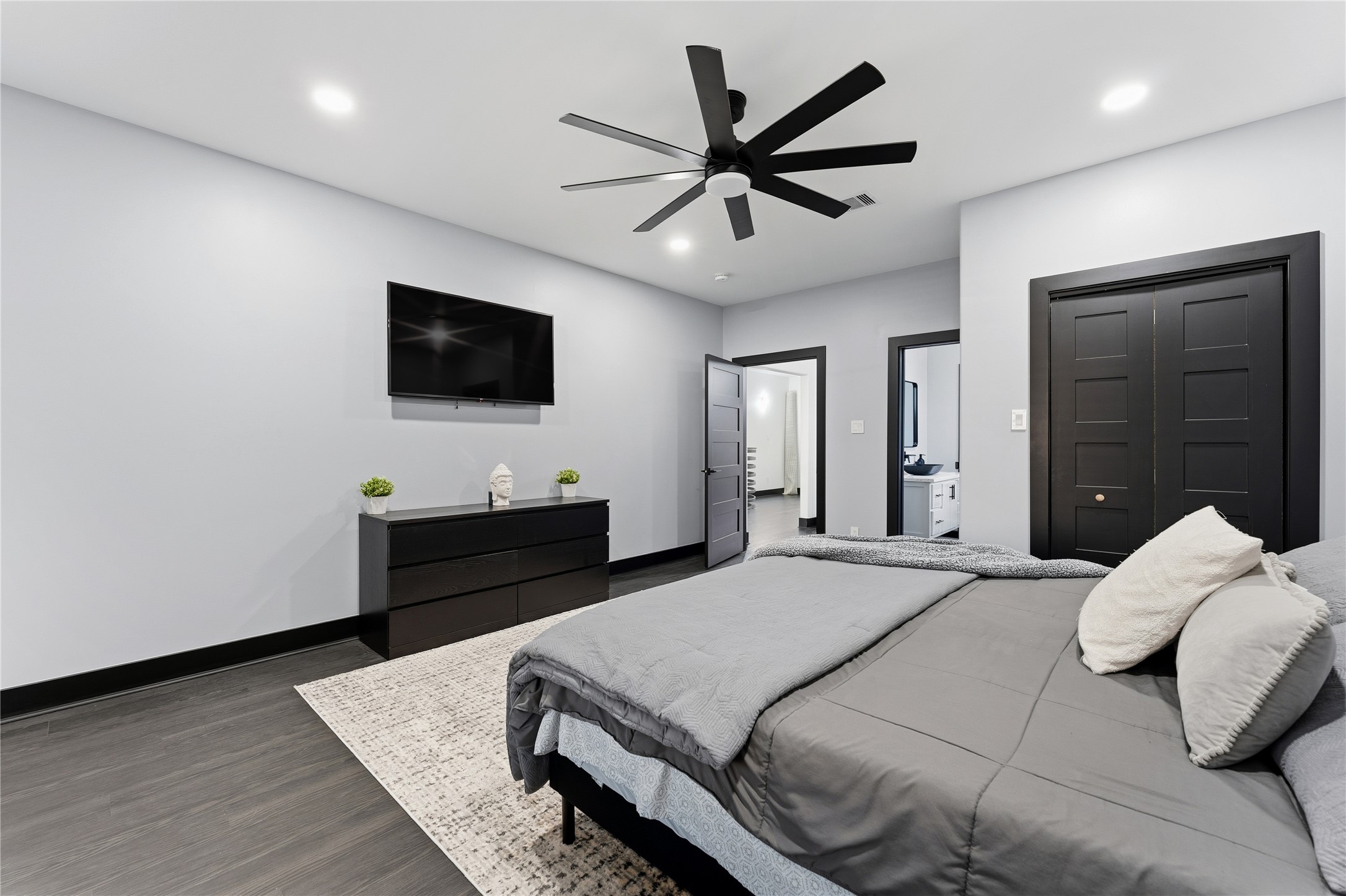 7737 Edna Street Houston, TX 77087 - Photo 23 of 43 a bedroom with a bed and a flat screen tv