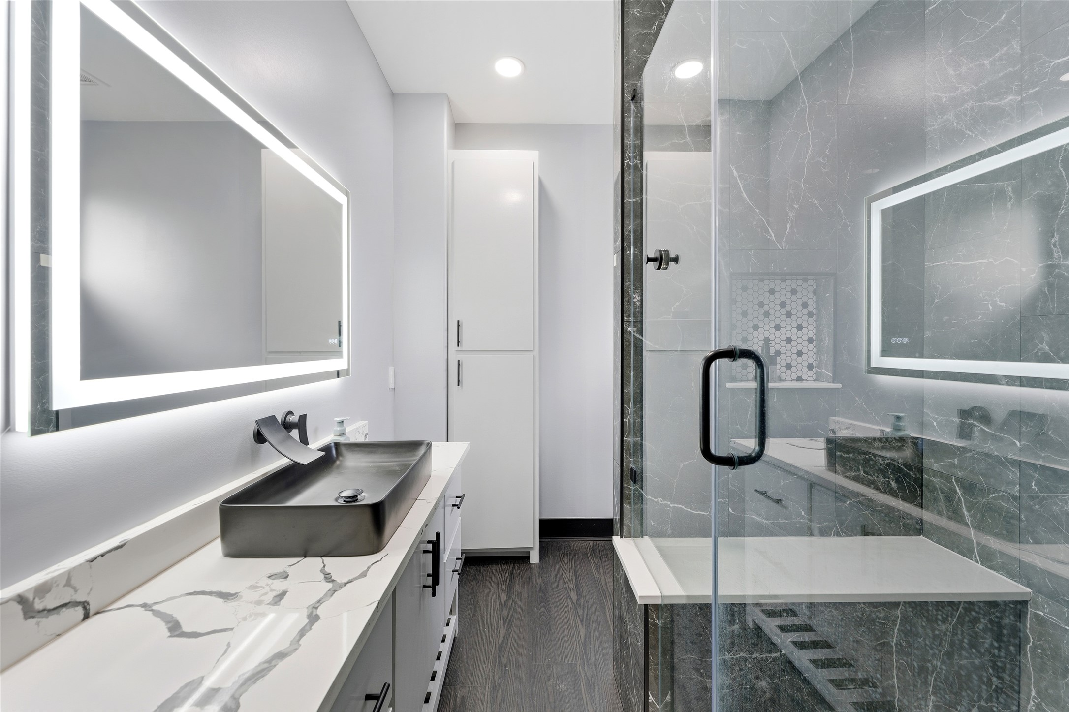 7737 Edna Street Houston, TX 77087 - Photo 33 of 43 a bathroom with a double vanity sink a mirror and shower