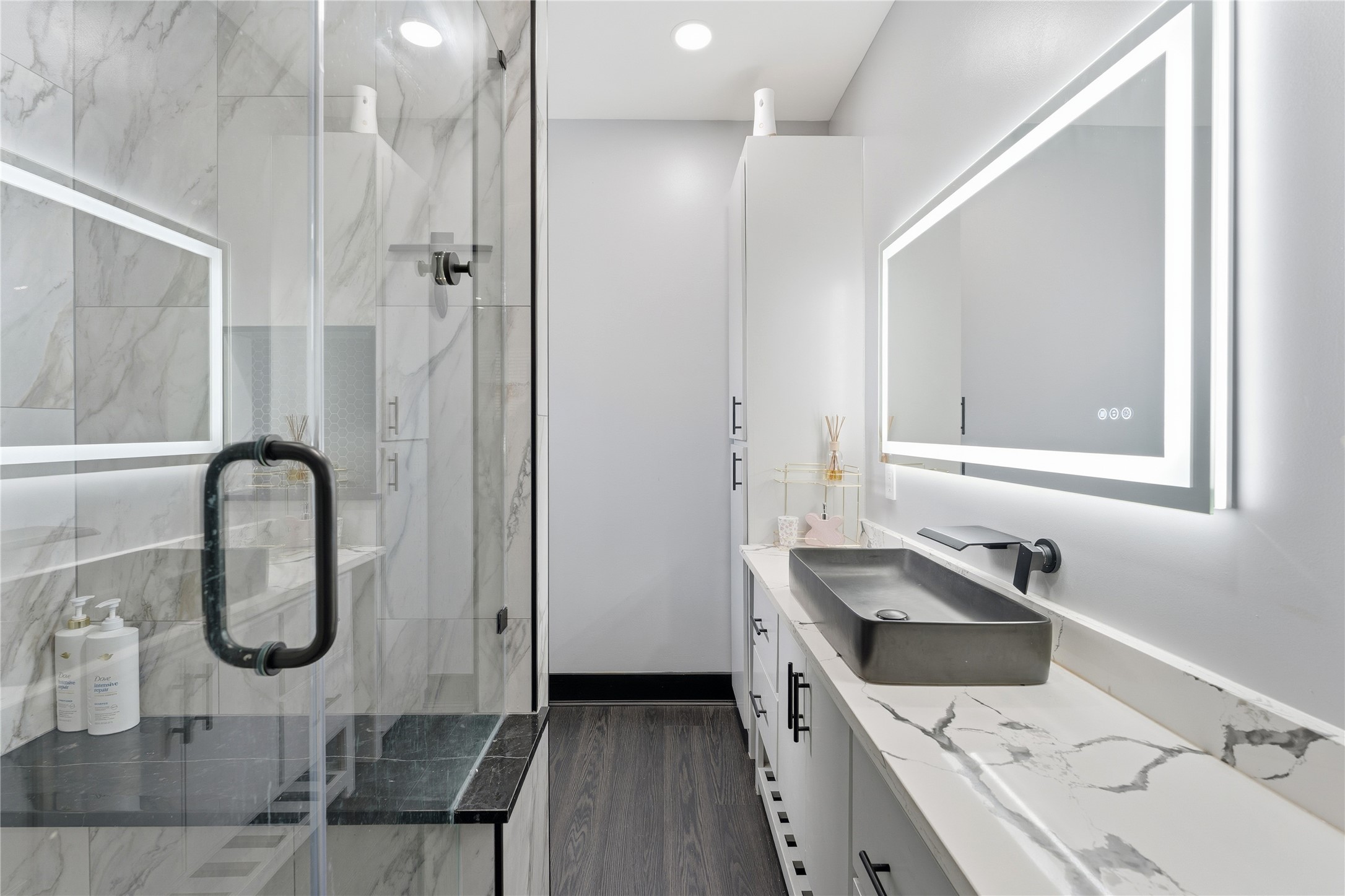 7737 Edna Street Houston, TX 77087 - Photo 35 of 43 a bathroom with a granite countertop sink a mirror and shower