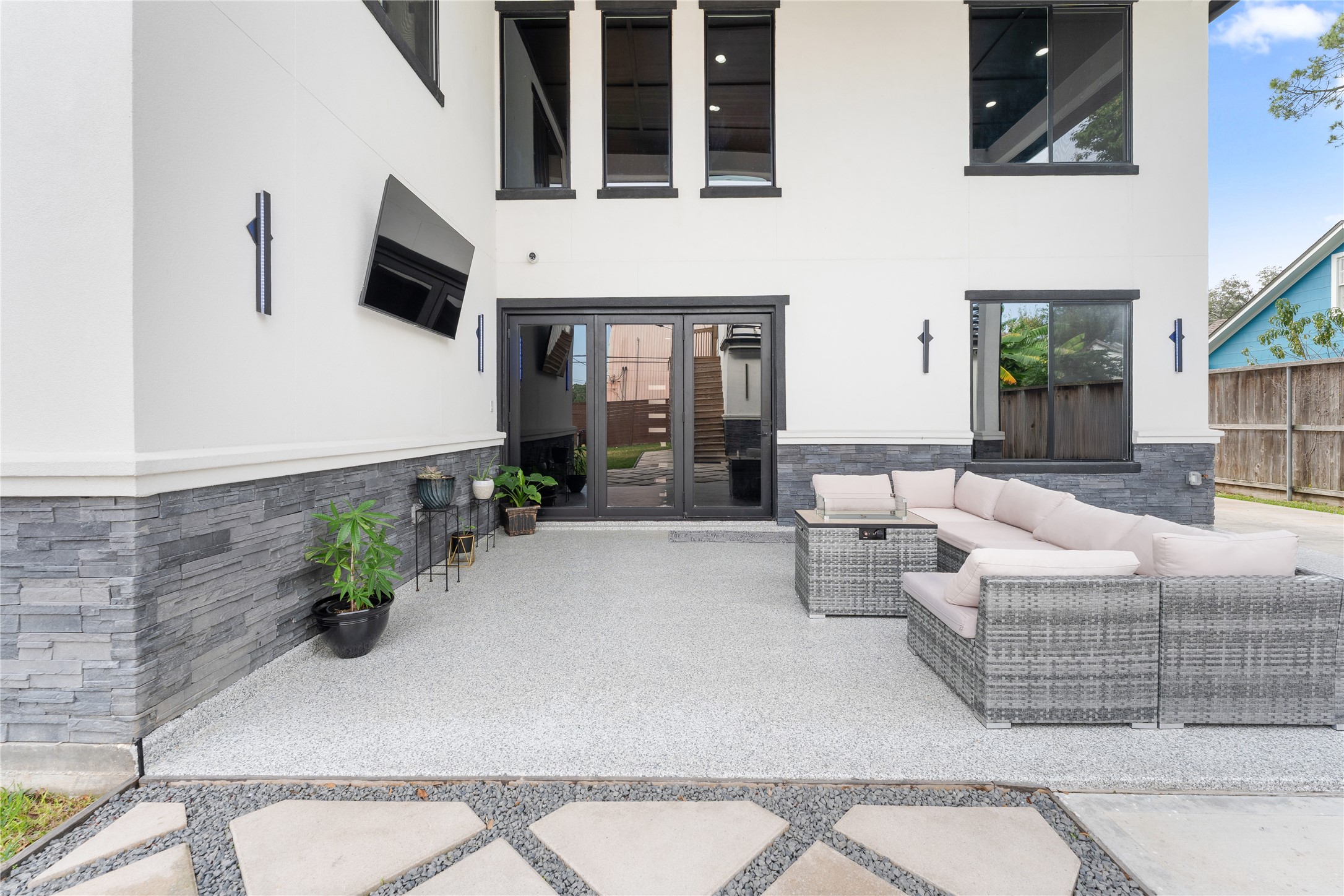7737 Edna Street Houston, TX 77087 - Photo 39 of 43 a living room with couches a flat screen tv and potted plant