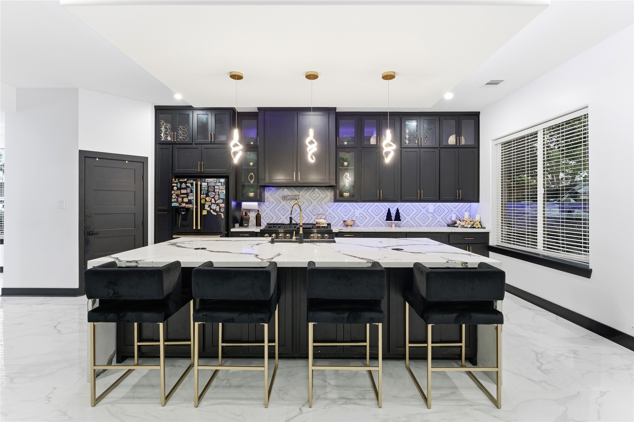 7737 Edna Street Houston, TX 77087 - Photo 6 of 43 a kitchen with a sink and chairs