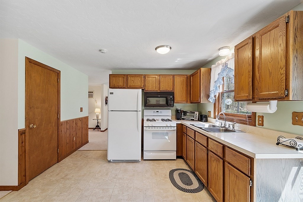 20 Rhodes Road Princeton, MA 01541 - Photo 13 of 35 a kitchen with a refrigerator a stove a sink dishwasher and cabinets with wooden floor