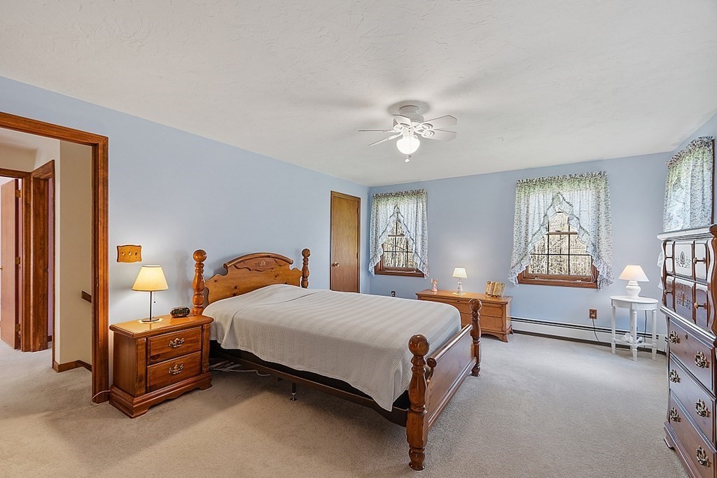 20 Rhodes Road Princeton, MA 01541 - Photo 17 of 35 a bedroom with a bed and a chandelier