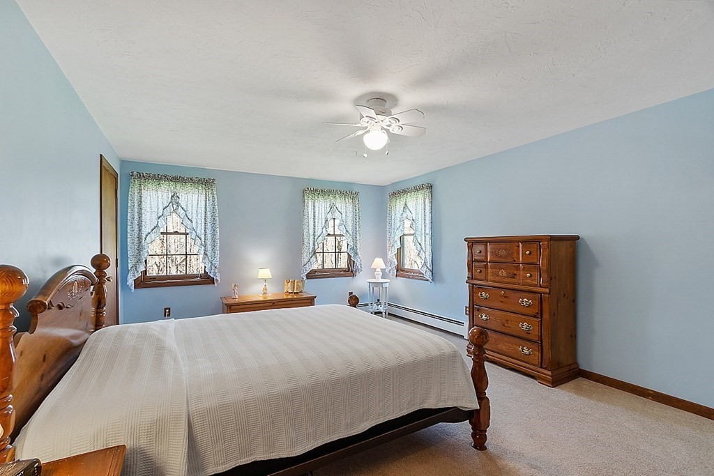 20 Rhodes Road Princeton, MA 01541 - Photo 19 of 35 a bedroom with a bed and a dresser next to a window